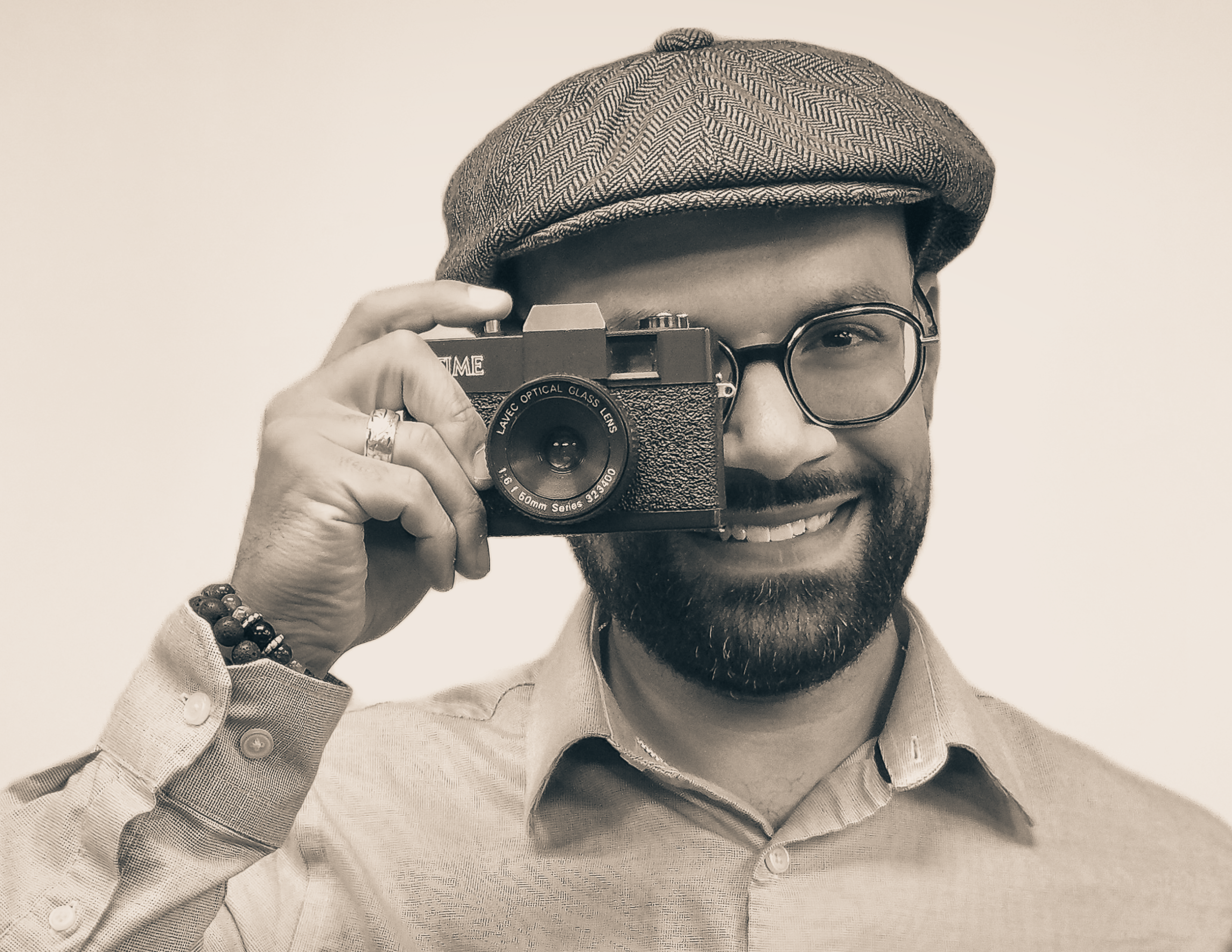 Portrait of Joseph Moyer holding a camera.